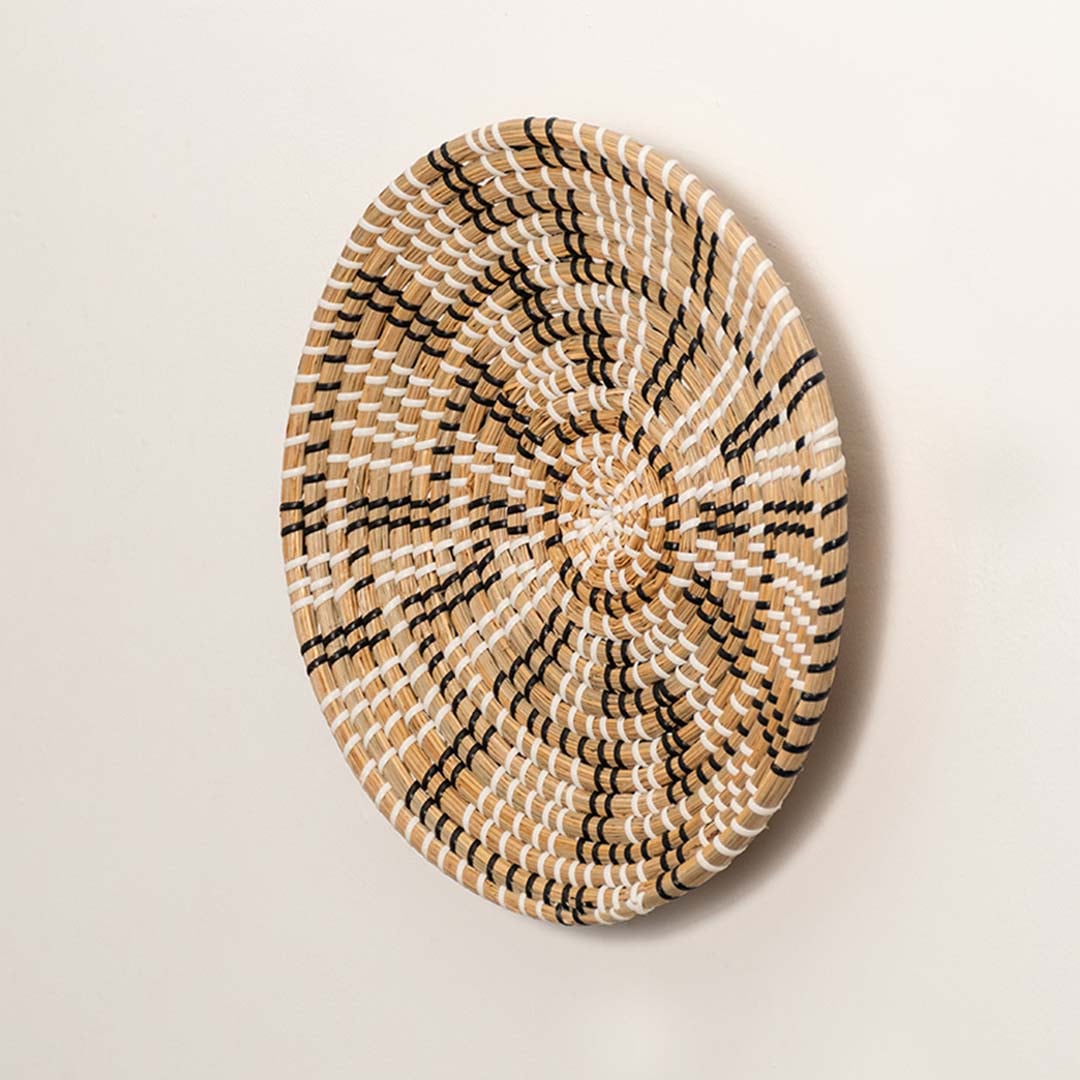 Side angle of woven wall basket showing depth rounded weaving and durable construction of natural seagrass fibers.
