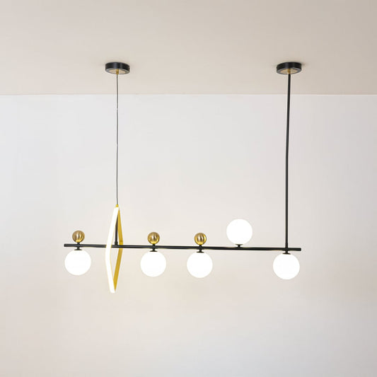 Black and gold linear pendant light illuminated on white background showcasing balanced globe spacing and modern design.