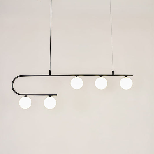 Black asymmetrical ceiling light with globe shades in a front view against a plain wall background with lights on ideal for contemporary lighting décor.