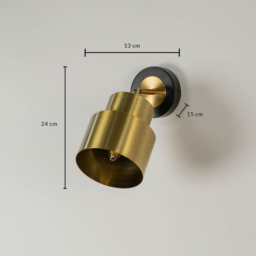Cylindrical gold metal wall light showing 22 cm height 17 cm depth and 10 cm backplate suitable for bedside lighting.