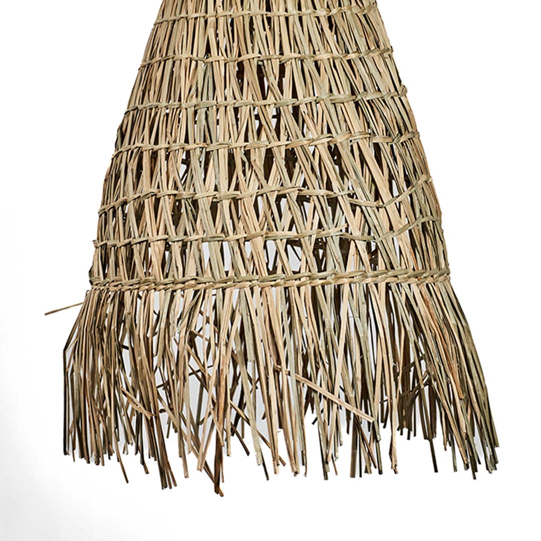 Rattan pendant light closeup focusing on layered weave pattern and fringe detailing creating artisanal boho ceiling lighting appeal.