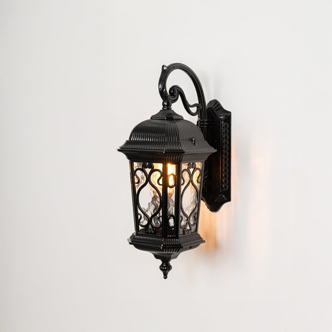 Classic outdoor wall light in black with glass panels and decorative frame displayed on white background for styling.
