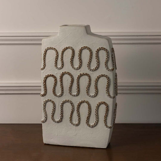 White sculptural ceramic vase displayed on white background featuring wavy embossed pattern for modern artistic home decor styling.