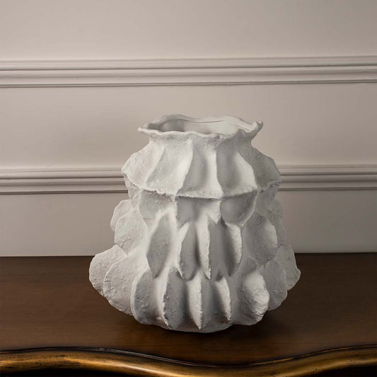 White textured round ceramic vase displayed on white background highlighting subtle pattern smooth curves and elegant decor placement.