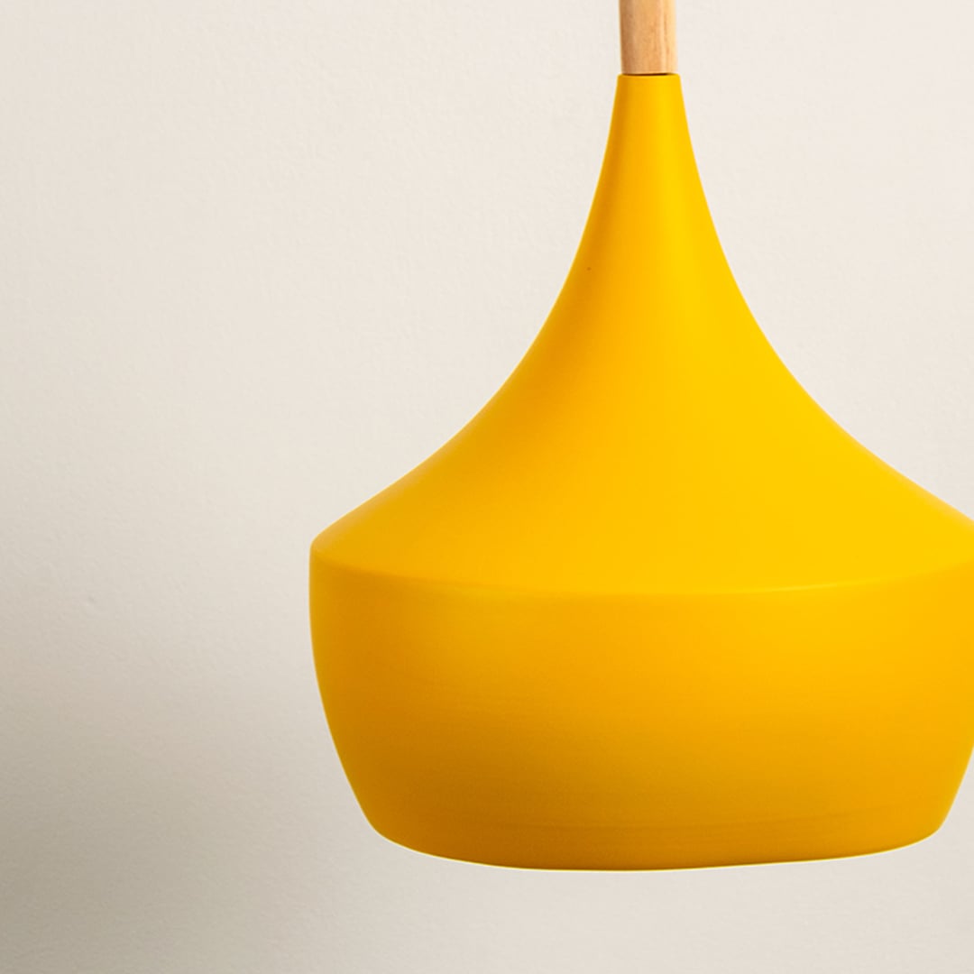 Yellow metal pendant light with soft rounded form and wooden top styled on white background for modern interior ceiling decor.