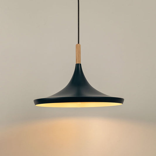Blue pendant light glowing against a white background highlighting its smooth matte finish and wooden accent.
