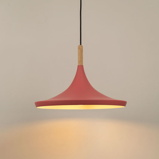Pink pendant light glowing softly against a neutral white background showcasing its smooth matte finish and minimalist design.