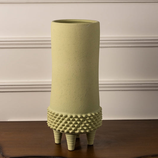 Elegant light green textured ceramic vase with matte finish and tripod stand on white background for decor styling.
